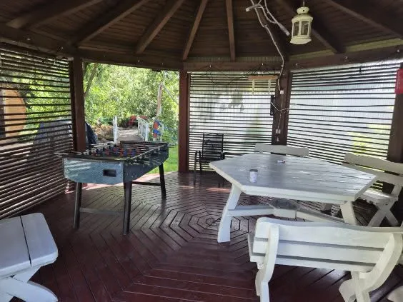 Gazebo with a foosball table and seating area