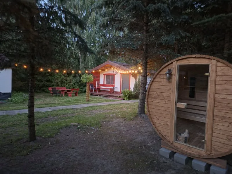 Cottage and sauna in the evening, garden lighting
