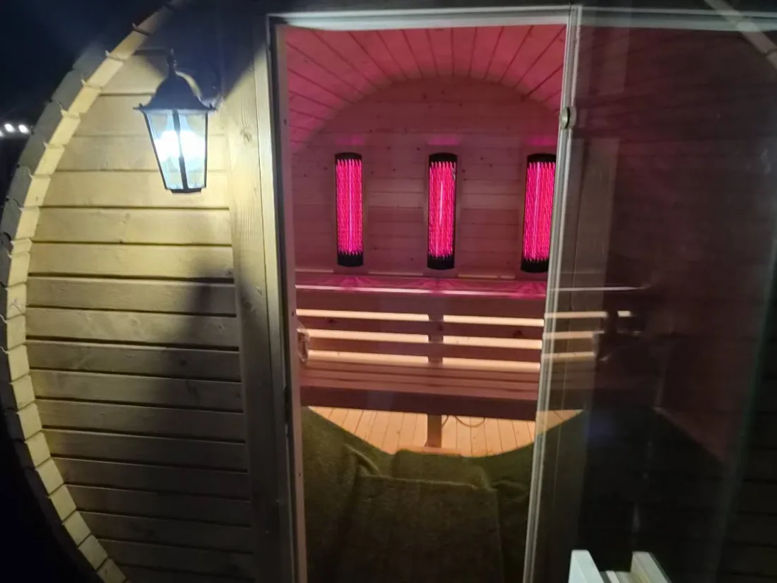 Barrel sauna from the entrance, evening lighting
